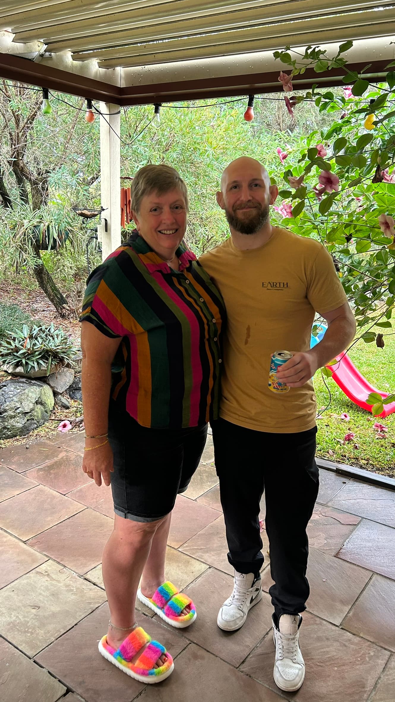 Kay and Hayden smiling together on a garden patio